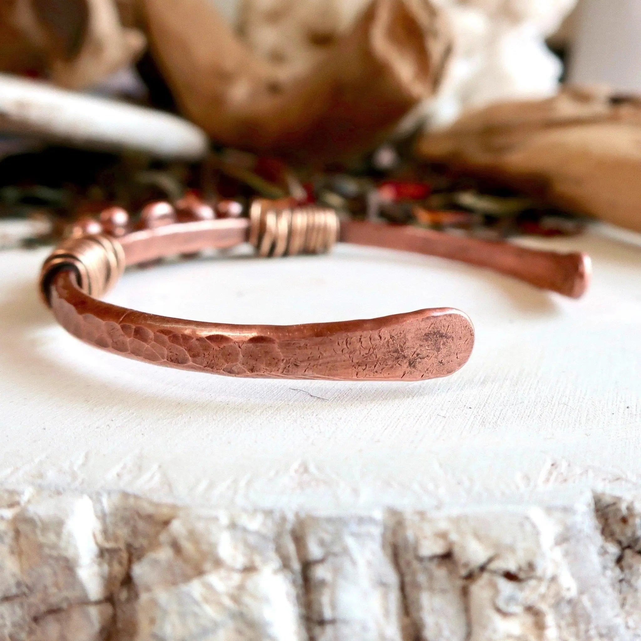 Copper Bracelet was hammered and texturized, free style. The cuff is flame painted with a torch and covered 2024 by a protective coat